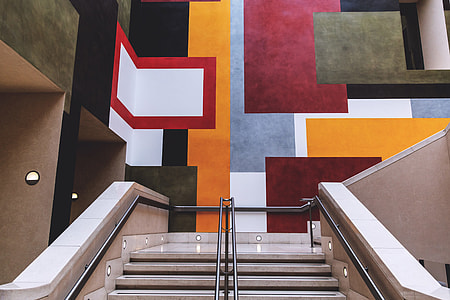 Staircase interior leading up to vibrant wall art in a building in London thumbnail