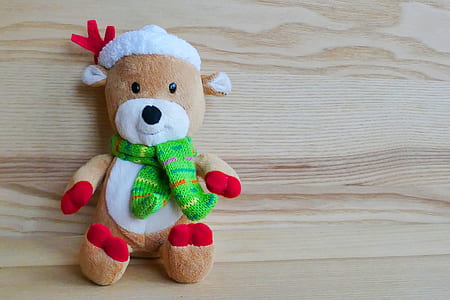 brown and white bear plush toy on top of brown wooden surface thumbnail