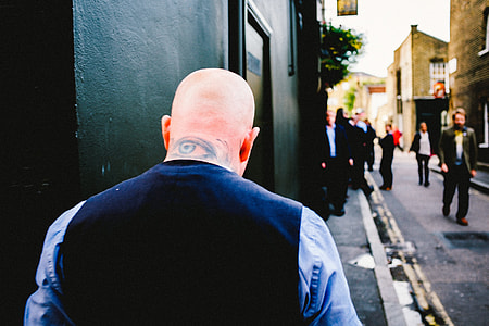 man wearing blue vest and white long sleeved dress shirt thumbnail