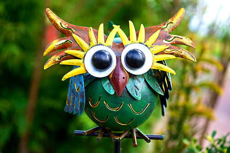 green and brown wooden owl figurine thumbnail