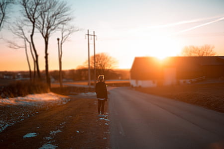 person standing near road during daytime thumbnail