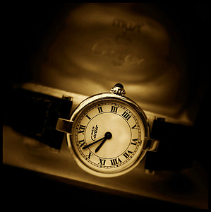 round silver-colored Cartier analog watch with black leather strap thumbnail