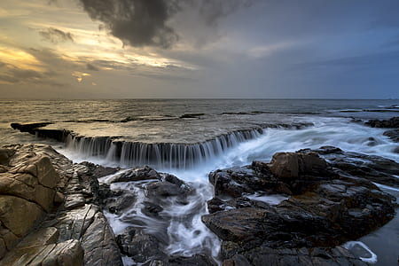 time laps photography waterfalls at cloudy sky thumbnail