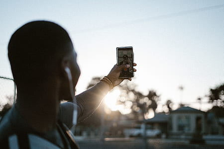 man taking selfie during golden hour thumbnail