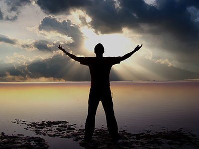 man standing in front of a body of water thumbnail