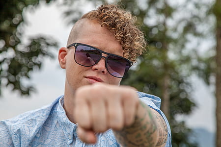 man wearing blue shirt showing fist thumbnail