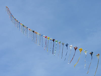 lined assorted-color kite on sky thumbnail