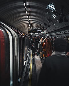 group of people walking beside train thumbnail