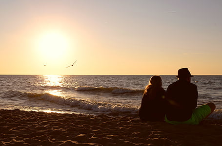 silhouette of man and woman on brown sand during daytime thumbnail