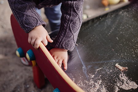 child putting hand on surface thumbnail