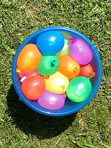 bucket of water balloons on green grass thumbnail