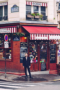 man standing beside shop thumbnail