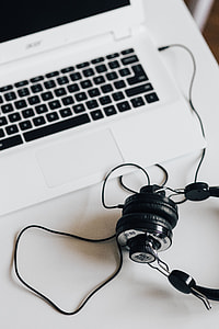 White laptop with smartphone and headphones thumbnail