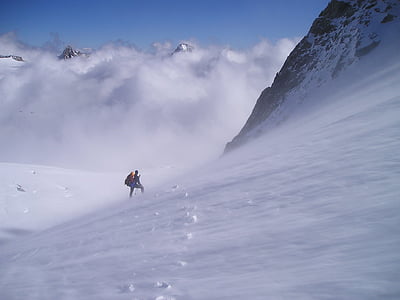 person climbing snowy mountain thumbnail