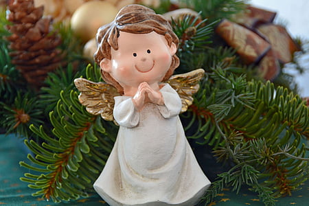 white and brown angel ornament on christmas tree thumbnail