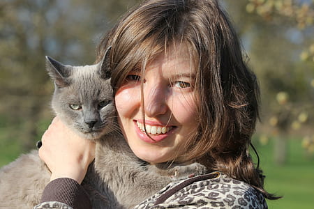 woman smiling while holding gray cat thumbnail