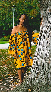 woman standing beside tree during daytime thumbnail