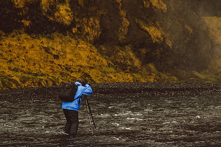 man taking photo on body of water thumbnail