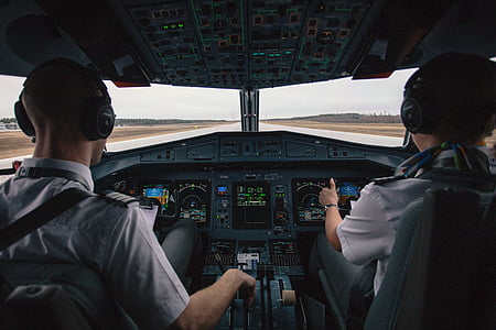 two pilots sitting on cockpit seats thumbnail