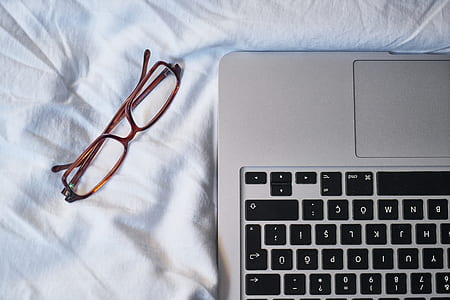 eyeglasses beside laptop thumbnail