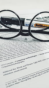 closeup photo of eyeglasses on paper thumbnail
