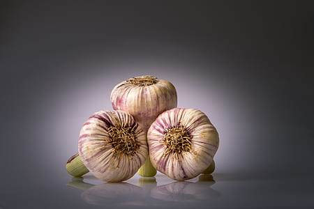 selective focus photography of three garlic bulbs thumbnail