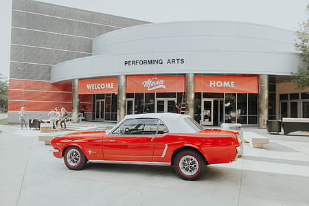 red convertible car parked in front of performing arts theater thumbnail