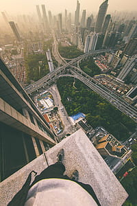person standing on building looking on city thumbnail