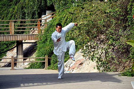 man wearing white suit doing karate thumbnail