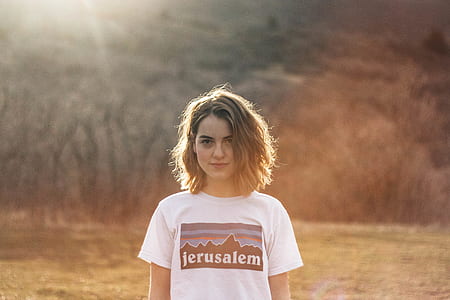 woman standing in front of trees during daytime thumbnail
