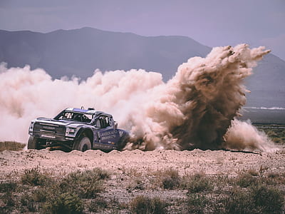blue and white truck on sand thumbnail