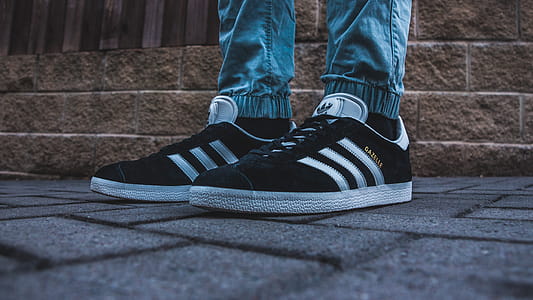 Person Wearing Pair of Black-and-white Adidas Gazelle thumbnail