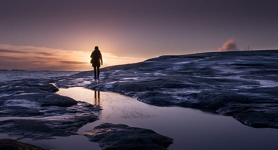 silhouette of person on beach sand thumbnail