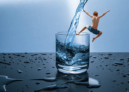 man jumping on clear rock glass filled of water i thumbnail