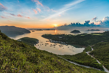 hills near river under calm sky thumbnail