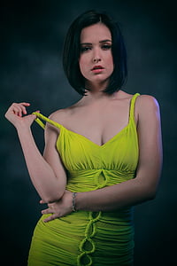 woman in green dress holding her dress's strap thumbnail