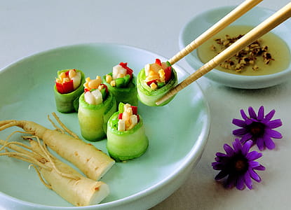 Vegetable Covered With Food Wrapper on Green Bowl With Chopstick Beside Purple Flower thumbnail