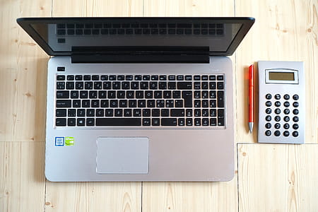 Macbook Pro Beside Gray Rectangular Device thumbnail