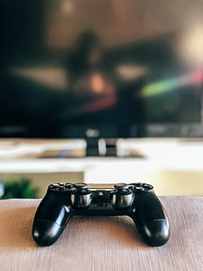shallow focus photography of black Sony DualShock 4 thumbnail