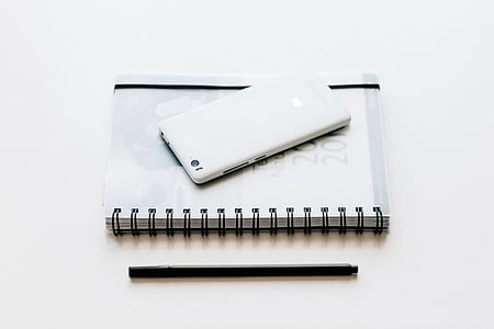 white Android smartphone on top of book beside pen thumbnail
