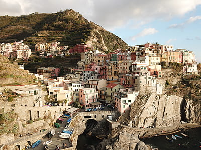 assorted-color houses near body of water thumbnail