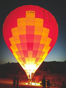 group of people looking on red and yellow hot air balloon thumbnail