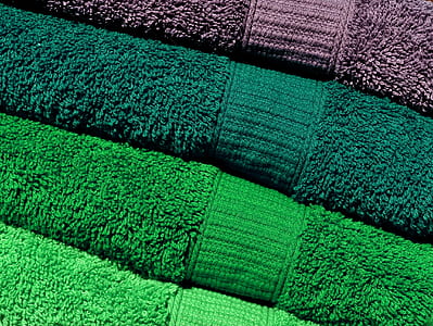 three green and one brown towels thumbnail