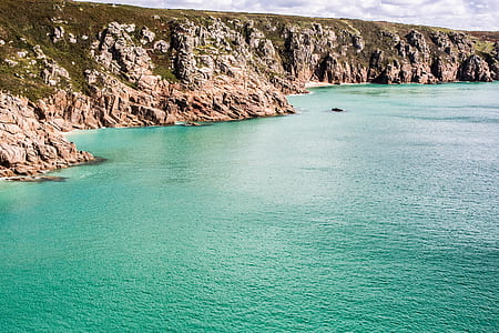 body of water near mountain thumbnail