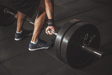Man in Black Reebok Shoes About to Carry Barbell thumbnail