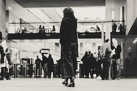 grayscale photography of woman in building thumbnail
