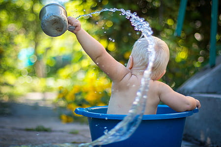 baby's holding gray steel water dipper photography thumbnail