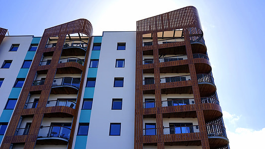low angle photo of brown and white high-rise building thumbnail