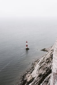 lighthouse in the middle of water thumbnail