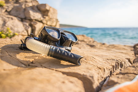 black goggles near body of water during daytime thumbnail